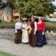 Four ladies dressed in Victorian outfits