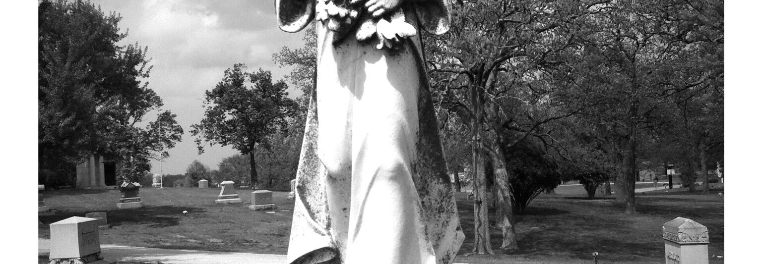 gravestone statue of girl holding flowers