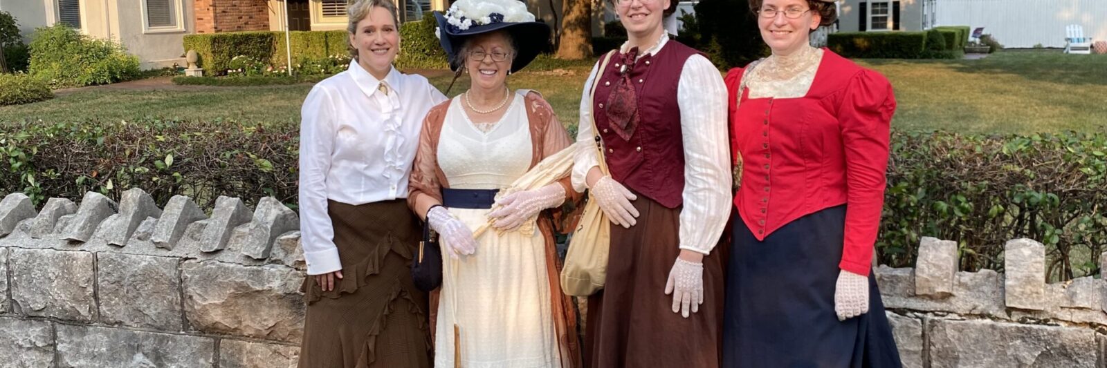 Four ladies dressed in Victorian outfits