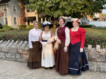 Four ladies dressed in Victorian outfits