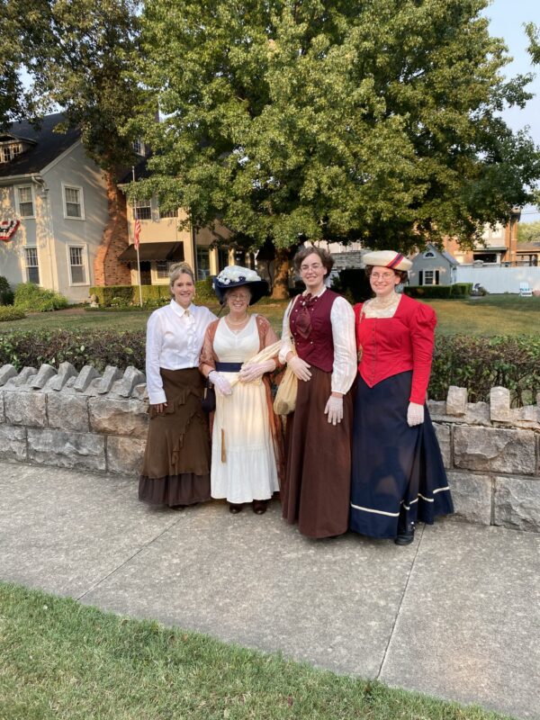 Four ladies dressed in Victorian outfits