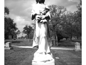 gravestone statue of girl holding flowers