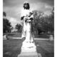 gravestone statue of girl holding flowers